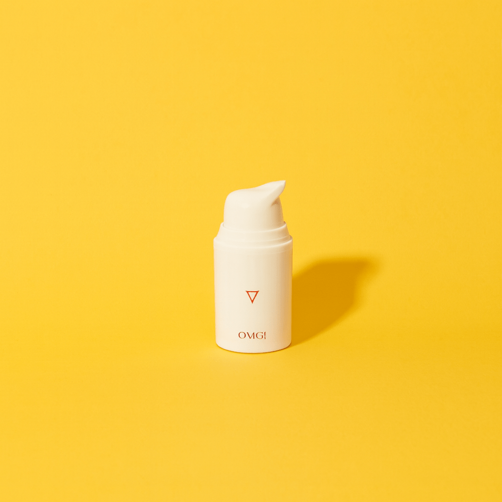 Minimalist photo of a white estriol-based “Oh My God Cream” bottle on a Sunshine-yellow background, representing hormone-based skincare for perimenopause and menopause and illustrating key ingredients, benefits, and whether the product actually works.